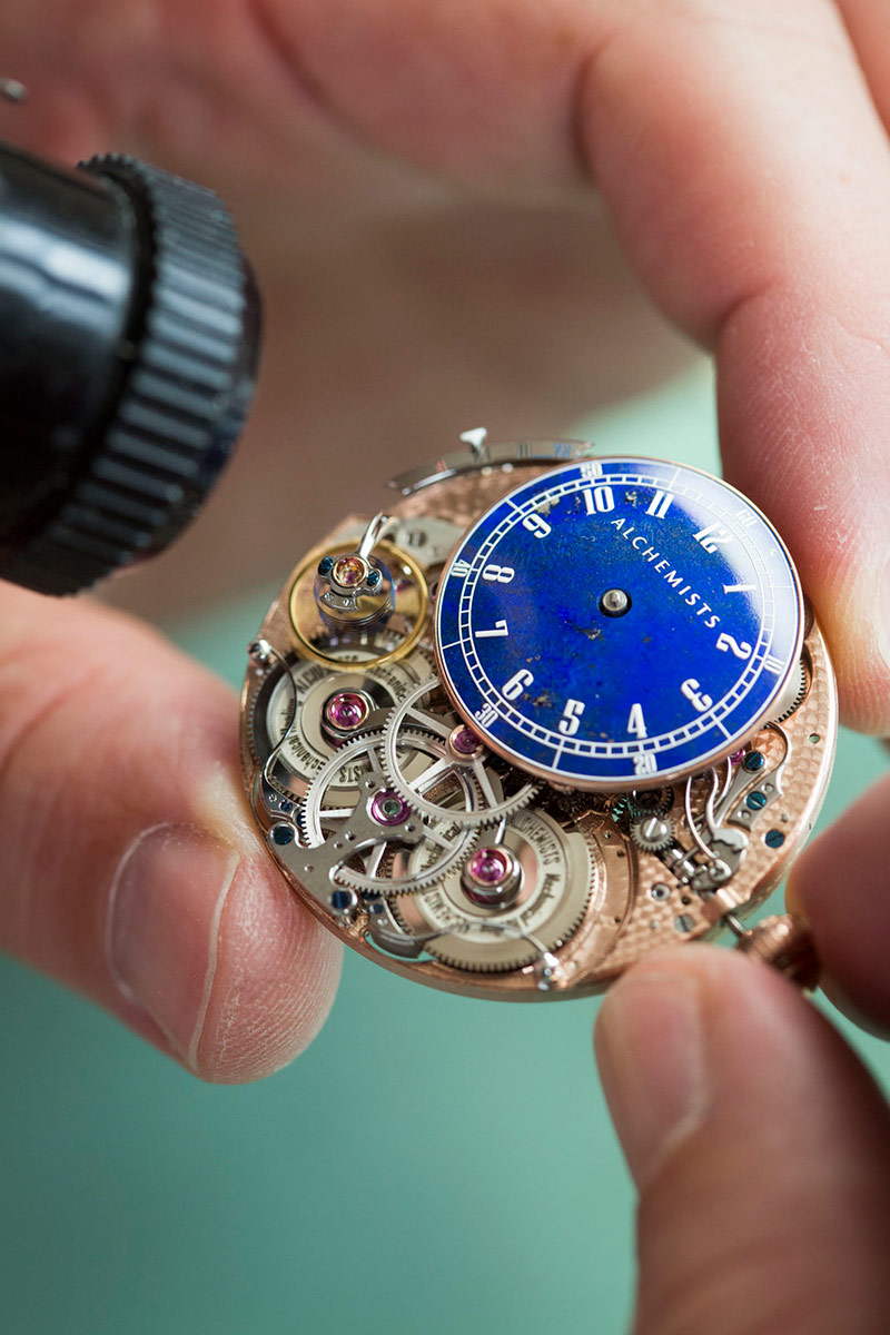 Closeup view of the Alchemists Cu29's movement, double barrels, hours dial and variable inertia balance